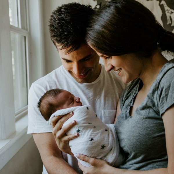 mom and dad holding baby